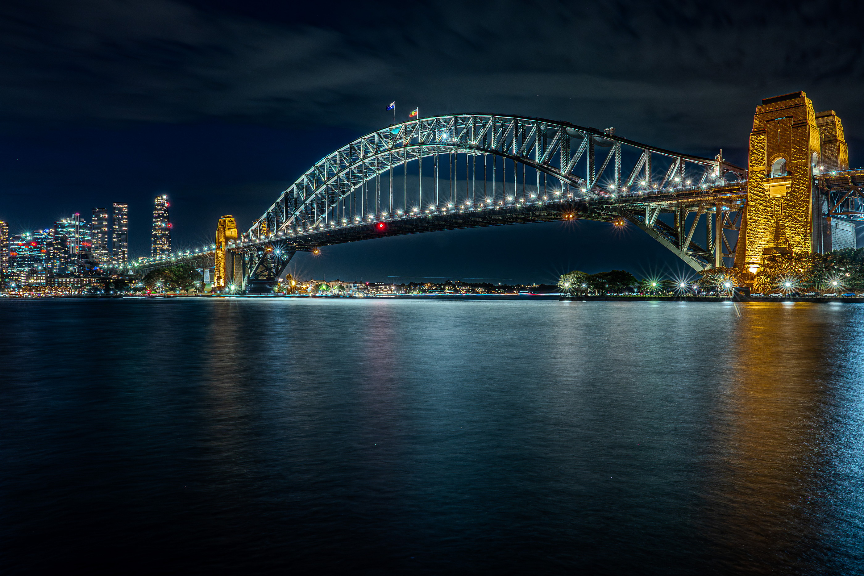 Sydney Harbour Bridge at night, long exposure over still water
